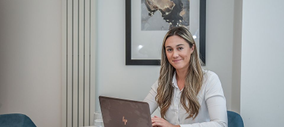 Woman on laptop smiling