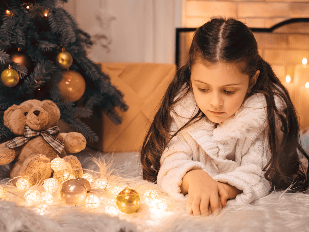 Unhappy child at Christams with Christmas lights in front of her